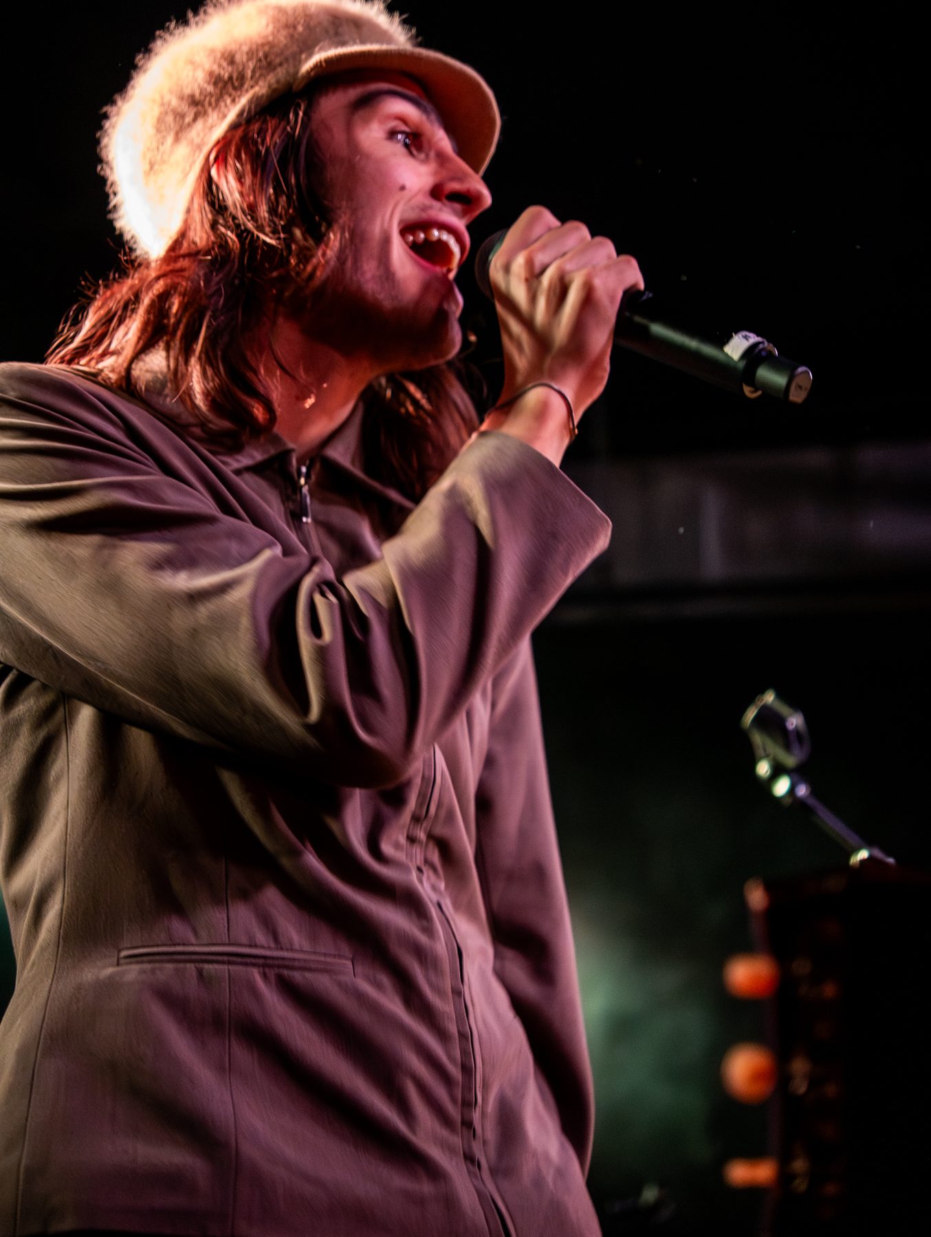 Singer performing on stage in warm lighting