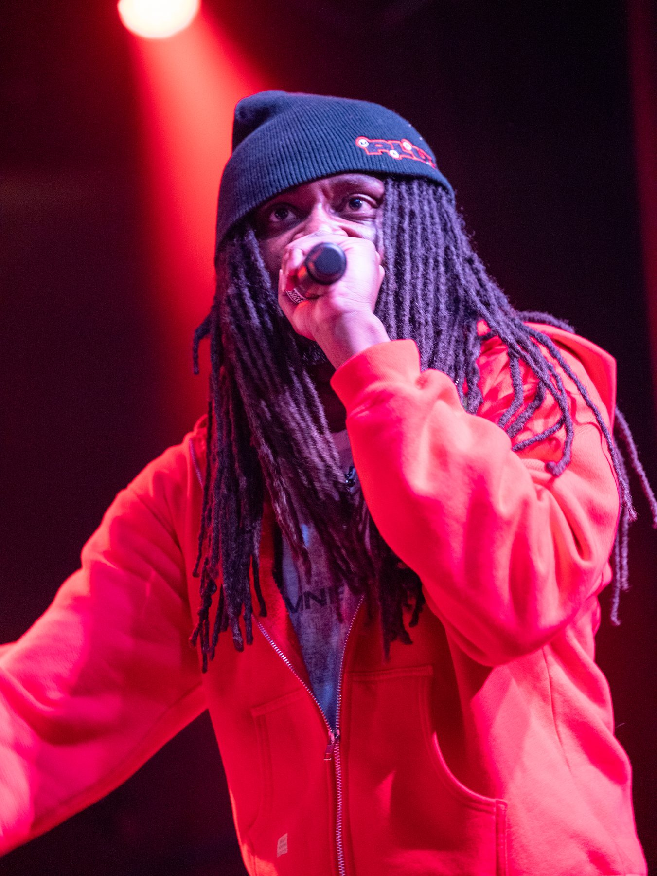 Live concert performance under red stage lighting