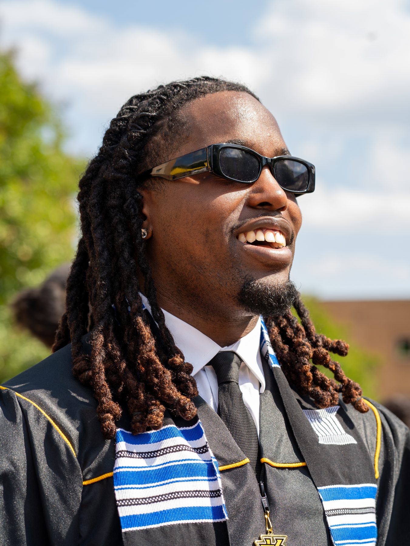 Portrait of a graduate smiling outdoors